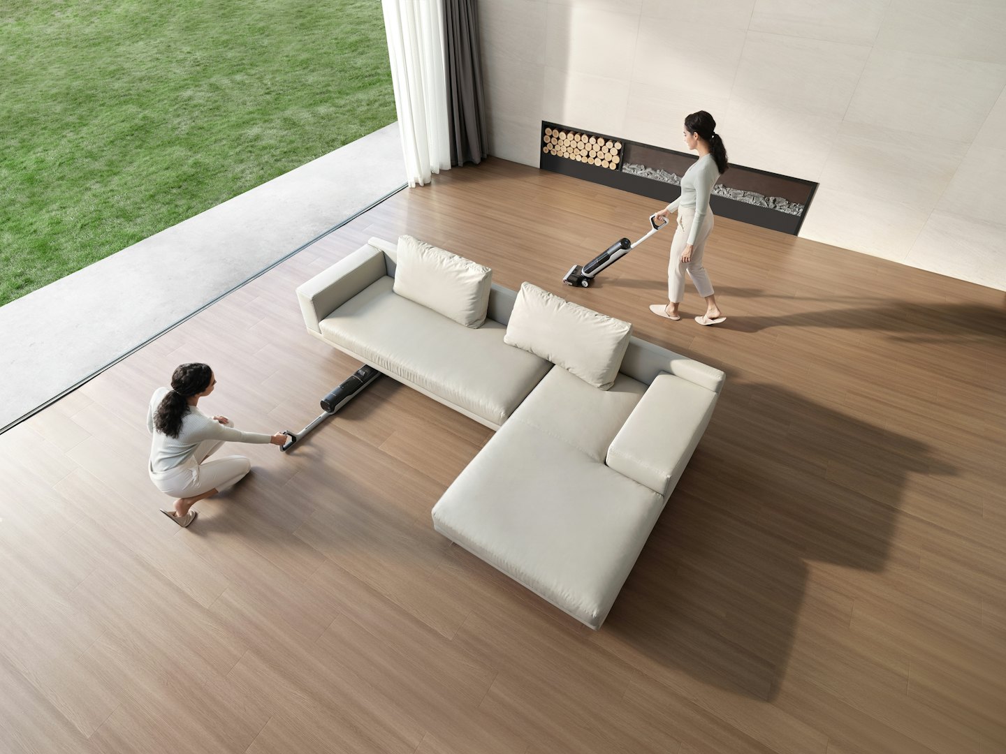 Two women clean a modern living room with a vacuum.